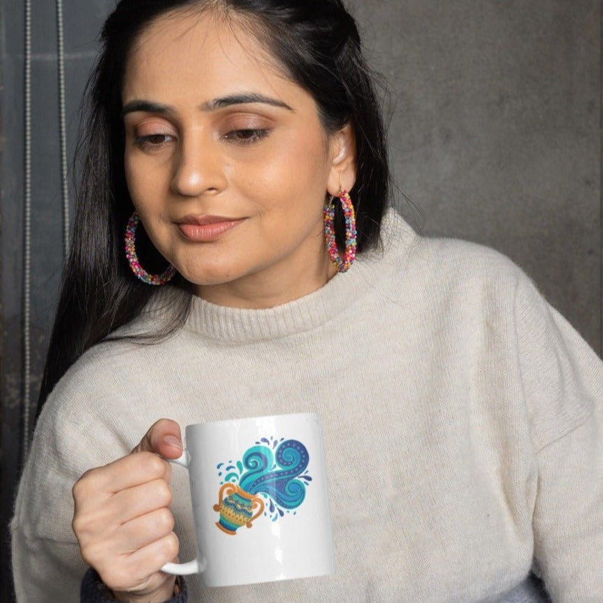 Image of Model holding Coffee Mug with Aquarius Sign designed by AK Pattern Studio