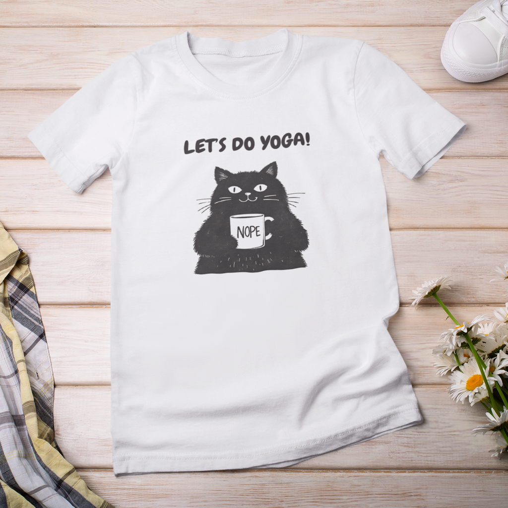 White t-shirt with black cat graphic and text 'LET'S DO YOGA!' on a wooden surface with a plaid shirt, sneakers, and flowers.
